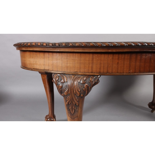 261 - A reproduction extending dining table in George III style, the oval top with gadroon lip above a dee... 