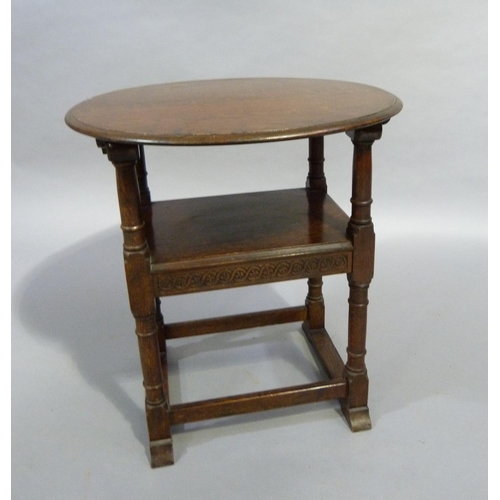 264 - A 1920/30's oak monks chair, the arch back carved with guilloche and folding over to create a table,... 