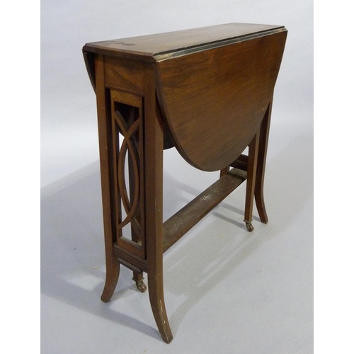 324 - A 1920's mahogany Sutherland table having twin oval drop leaves, refectory supports with pierced rai... 