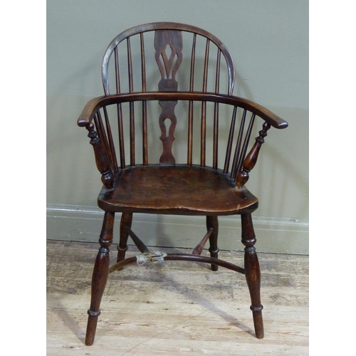 347 - A 19th century ash and elm low back windsor elbow chair with pierced splat, dished seat on turned le... 