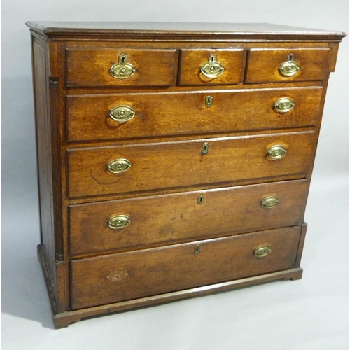 352 - A late C18th oak chest having three small drawers across and four long graduated drawers below, oval... 