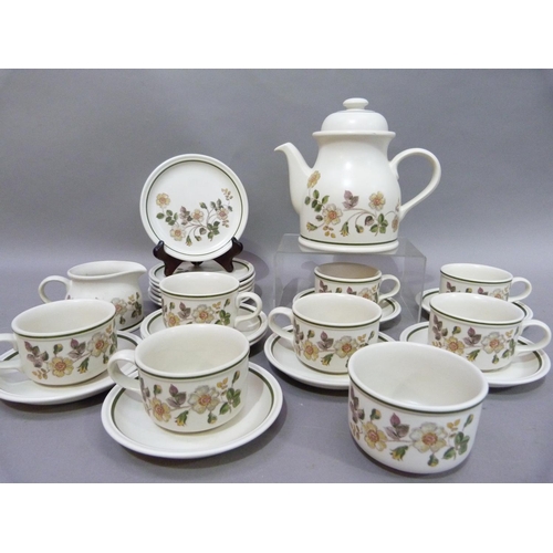 170 - A pottery coffee service printed with wild rose sprays on an ivory ground within a green rim line co... 