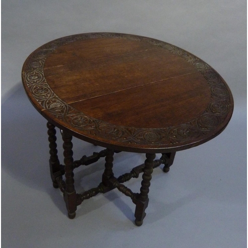 281 - An early 20th century oak oval dropleaf table with carved border and on bobbin turned and square fra... 