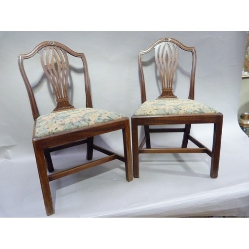 299 - A pair of early 20th century mahogany Hepplewhite  style chairs each having an arched back, pierced ... 