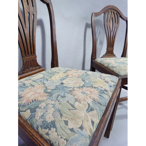 299 - A pair of early 20th century mahogany Hepplewhite  style chairs each having an arched back, pierced ... 