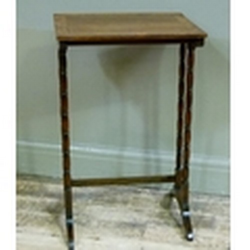 110 - An early 20th century rosewood occasional table on twin turned refectory standards from a nest of th... 