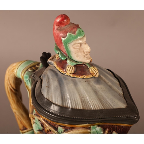 3 - A Minton towered jug, with pewter mounted lid with jester finial, the body relief moulded with medie... 