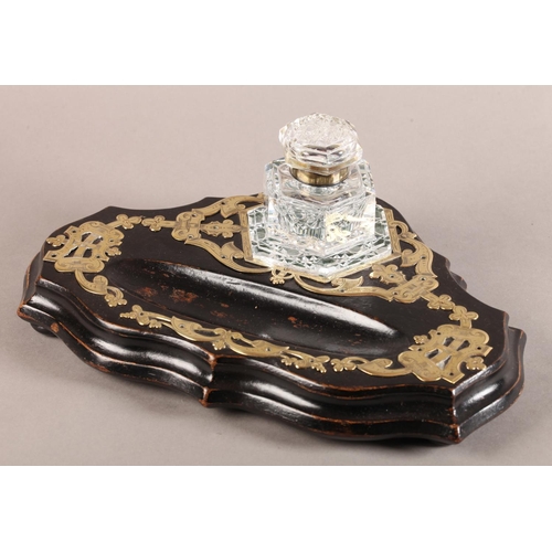 9 - A Victorian ebonised and cut brass strapwork desk standish fitted with a hobnail cut glass inkwell o... 