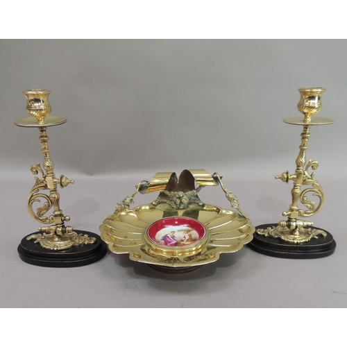 17 - A late 19th century brass dish of fluted shell form, the back with ribbon and garland carrying handl... 