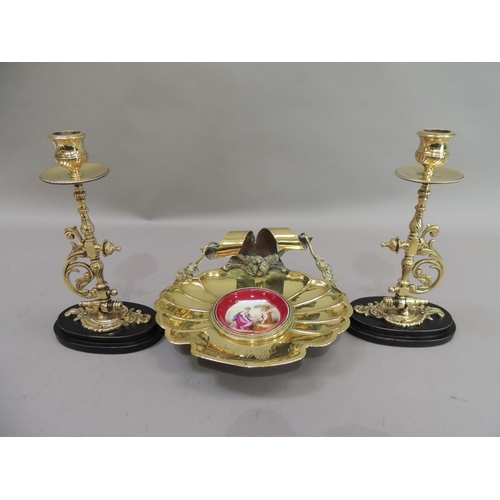 17 - A late 19th century brass dish of fluted shell form, the back with ribbon and garland carrying handl... 