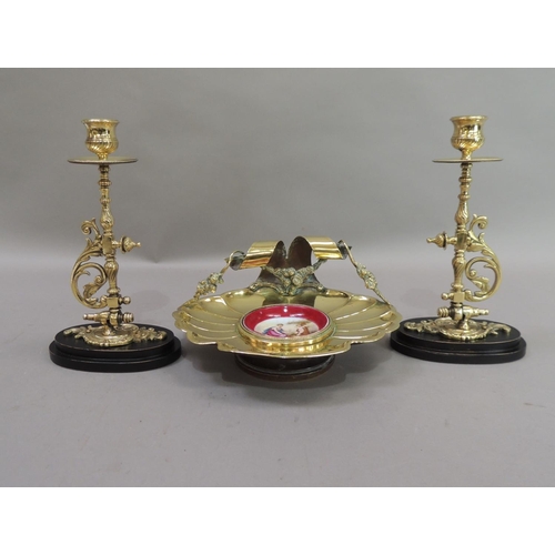 17 - A late 19th century brass dish of fluted shell form, the back with ribbon and garland carrying handl... 