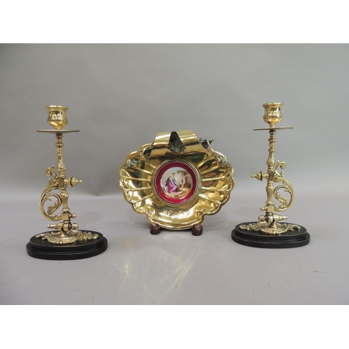 17 - A late 19th century brass dish of fluted shell form, the back with ribbon and garland carrying handl... 