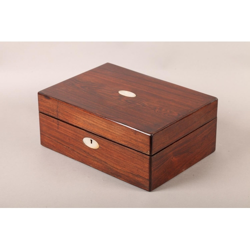 19 - A Victorian rosewood work box inlaid in mother-of-pearl with an oval cartouche and escutcheon, recta... 