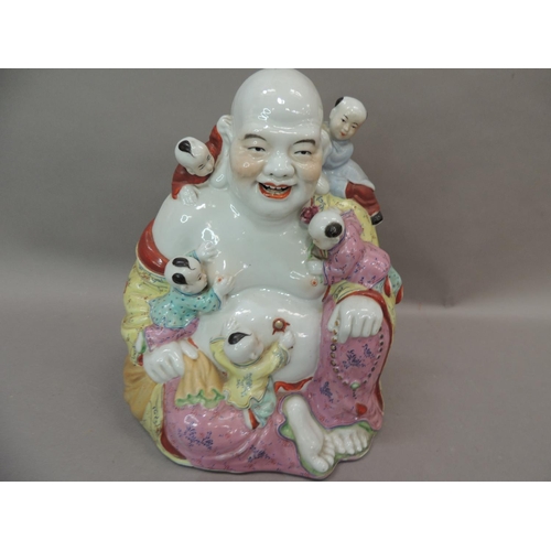 26 - A ceramic figure of Hotei, the buddha with small children climbing over him, 25cm high