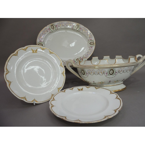 27 - A 19th century porcelain twin handled tureen with crenallated rim raised on an oval foot rim, the bo... 