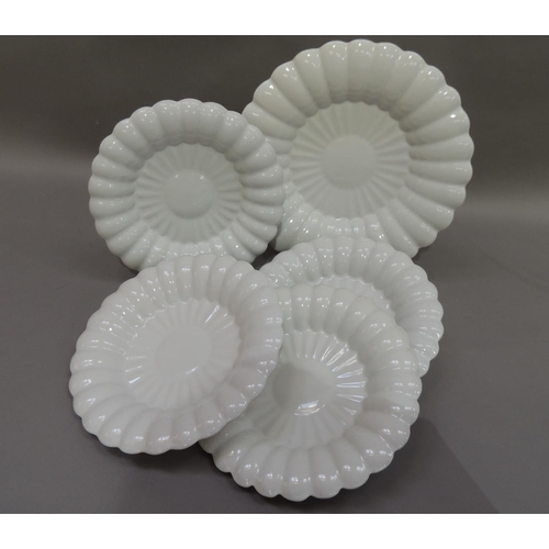 32 - A set of five white glazed pottery dishes by Makkum comprising four 25.5cm diameter and a serving di... 