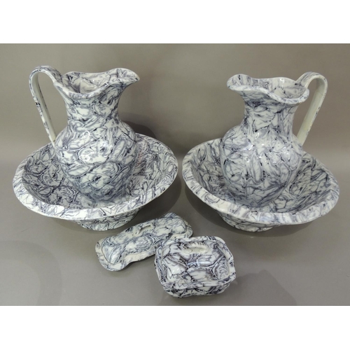30 - A Victorian six piece toilet set of grey marbled decoration comprising two water jugs, two bowls on ... 