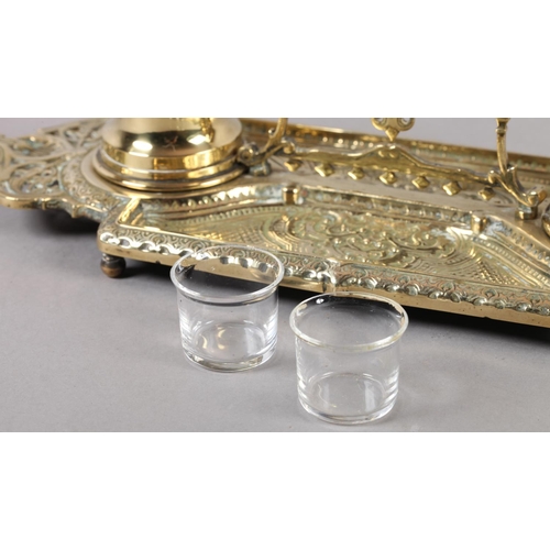 13 - A Victorian brass double desk standish fitted with two glass lined inkwells, pierced handle and oppo... 