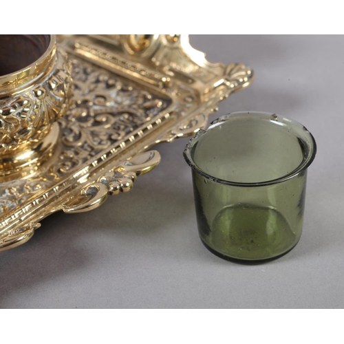 14 - A Victorian brass desk standish fitted with a central inkwell and cover cast with ribboned harebells... 