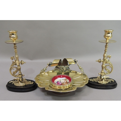 17 - A late 19th century brass dish of fluted shell form, the back with ribbon and garland carrying handl... 