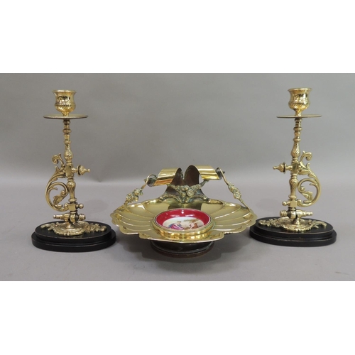 17 - A late 19th century brass dish of fluted shell form, the back with ribbon and garland carrying handl... 