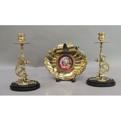 17 - A late 19th century brass dish of fluted shell form, the back with ribbon and garland carrying handl... 