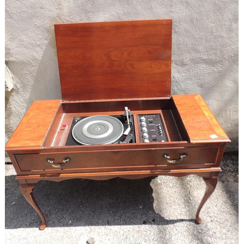 185 - A Dynatron radiogram with Garrard turntable contained within a walnut veneered case on shell carved ... 