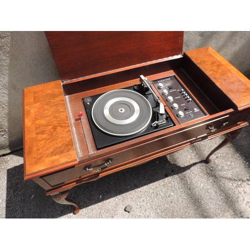 185 - A Dynatron radiogram with Garrard turntable contained within a walnut veneered case on shell carved ... 