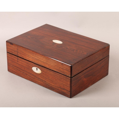 19 - A Victorian rosewood work box inlaid in mother-of-pearl with an oval cartouche and escutcheon, recta... 