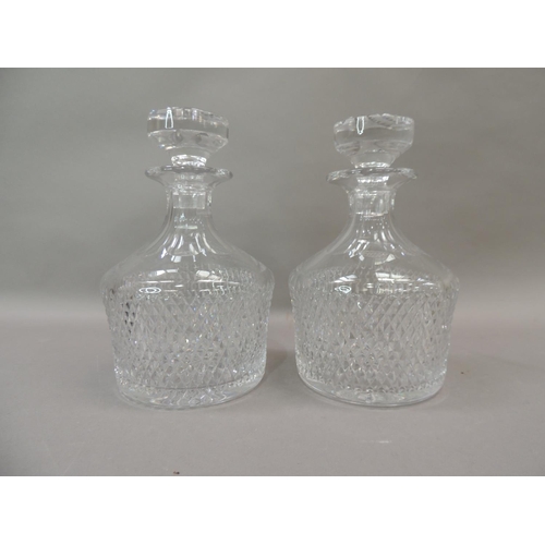22 - A pair of cut glass decanters and stoppers, 22cm high