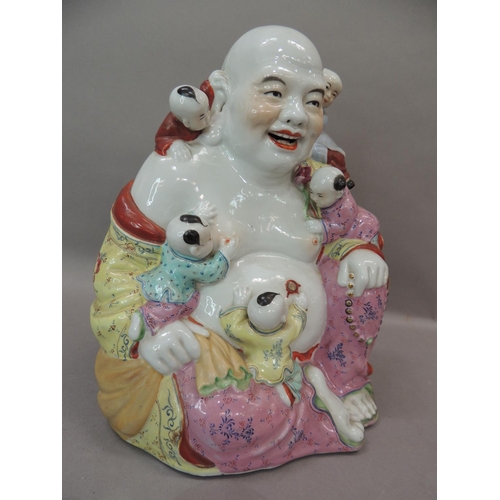 26 - A ceramic figure of Hotei, the buddha with small children climbing over him, 25cm high