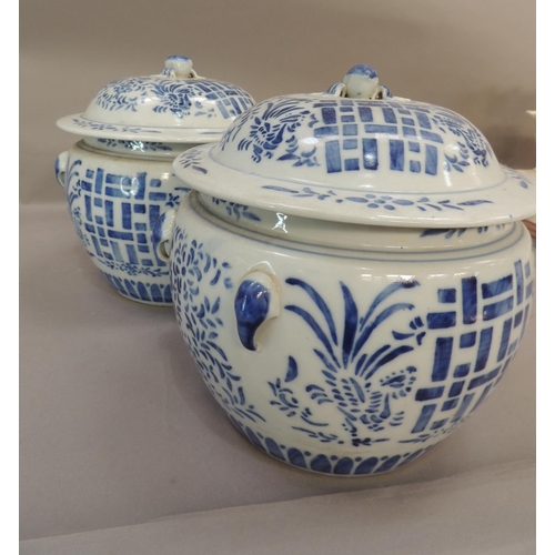 28 - A pair of Chinese blue and white jars and covers decorated with geometric panels with stylised flowe... 
