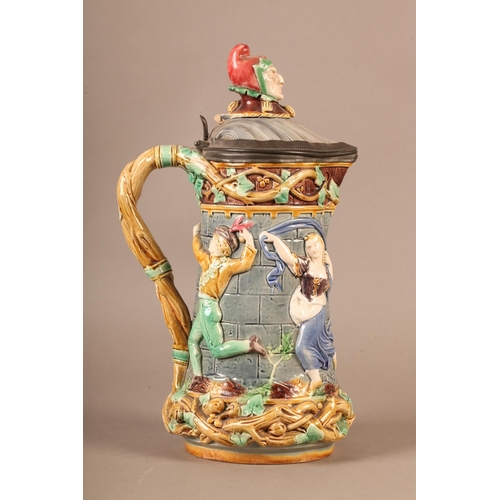 3 - A Minton towered jug, with pewter mounted lid with jester finial, the body relief moulded with medie... 
