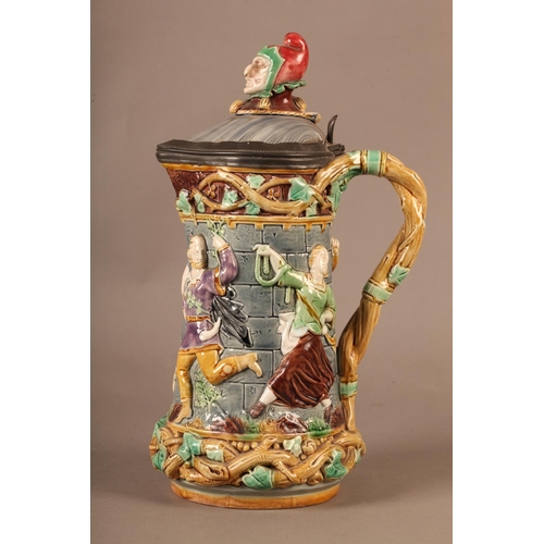 3 - A Minton towered jug, with pewter mounted lid with jester finial, the body relief moulded with medie... 