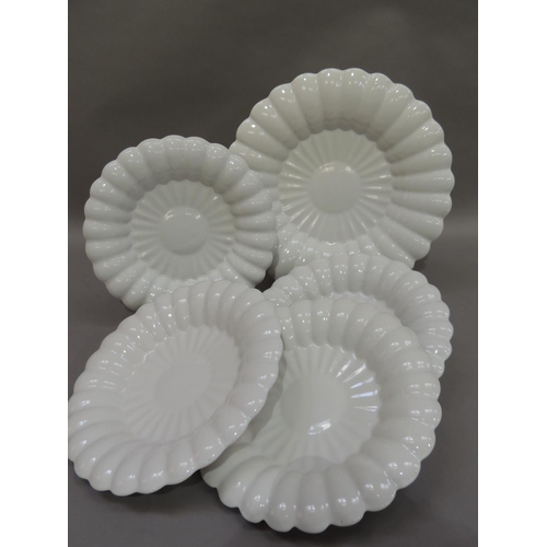 32 - A set of five white glazed pottery dishes by Makkum comprising four 25.5cm diameter and a serving di... 