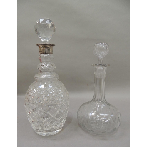35 - A silver mounted cut glass decanter with facetted globular stopper, silver neck, triple collar and c... 