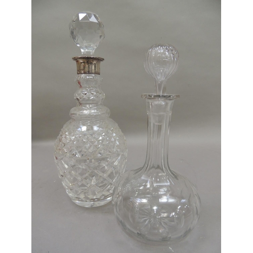 35 - A silver mounted cut glass decanter with facetted globular stopper, silver neck, triple collar and c... 