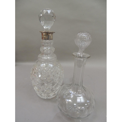 35 - A silver mounted cut glass decanter with facetted globular stopper, silver neck, triple collar and c... 