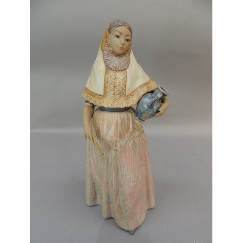 36 - A lladro figure of a young Spanish girl holding a picture beneath her left arm, a fan in her right h... 