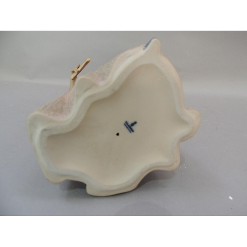 36 - A lladro figure of a young Spanish girl holding a picture beneath her left arm, a fan in her right h... 