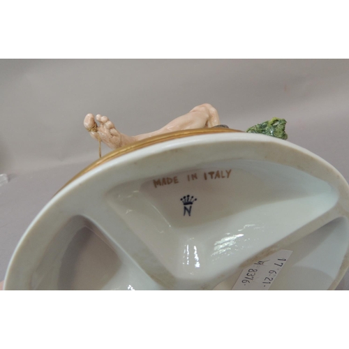 37 - A Naples porcelain figure of an elderly sleeping fisherman seated on the banks of a stream, 25cm hig... 