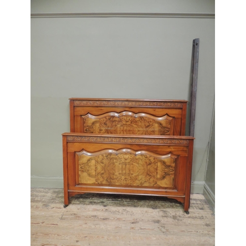 479 - A Victorian walnut double bedstead with grape and leaf carved frieze, figured panel under the foot b... 