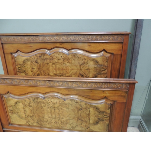 479 - A Victorian walnut double bedstead with grape and leaf carved frieze, figured panel under the foot b... 