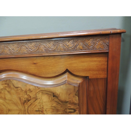 479 - A Victorian walnut double bedstead with grape and leaf carved frieze, figured panel under the foot b... 