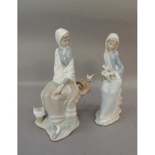 48 - Two Lladro porcelain figures, one modelled as a girl with cala lillies in her lap the other with gir... 