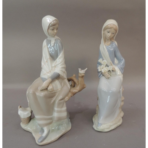 48 - Two Lladro porcelain figures, one modelled as a girl with cala lillies in her lap the other with gir... 