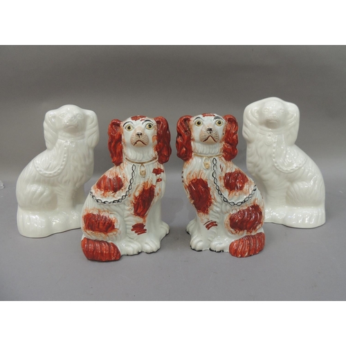 50 - A pair of  Victorian Staffordshire spaniels with rust red decorated bodies with gilt collars, black ... 