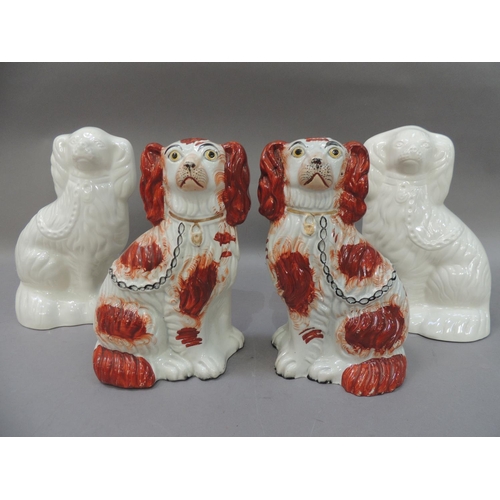 50 - A pair of  Victorian Staffordshire spaniels with rust red decorated bodies with gilt collars, black ... 