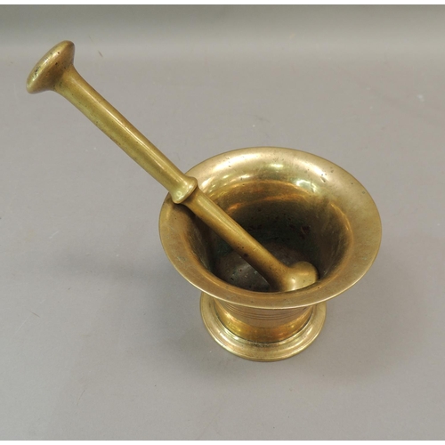 56 - An antique bronze pestle and mortar, tapered cylindrical form with reeded bands, mortar 8.5cm high, ... 