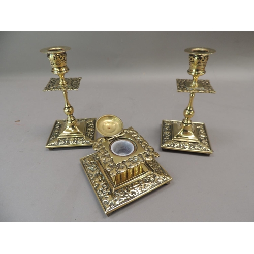 57 - A Victorian brass desk set comprising well and pair of candlesticks, the square ink well with foliat... 
